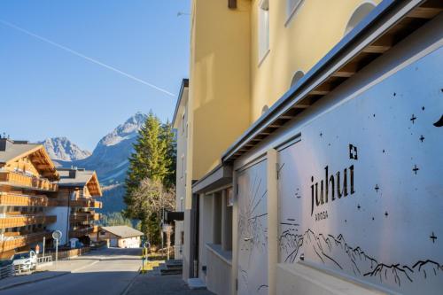 a building with a mural on the side of it at juhui Arosa in Arosa