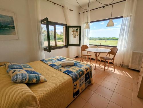 a bedroom with two beds and a table and chairs at El setè cel in Malgrat de Mar