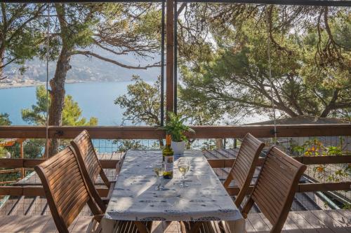 a table and chairs on a deck with a view of the water at Villaggio Smeraldo in Moneglia