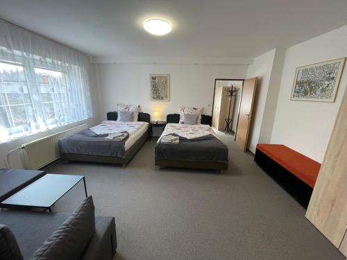 a hotel room with two beds and a couch at Apartmán Štěpánka in Jihlava
