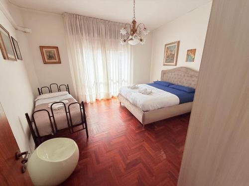 a bedroom with a bed and a table in it at Piazza Italia Charming Sea Apartments in Chioggia