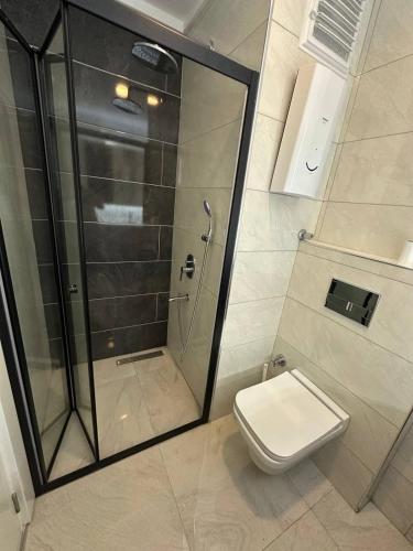 a bathroom with a shower and a toilet at Modern, Pool with slide,150m to beach in Alanya