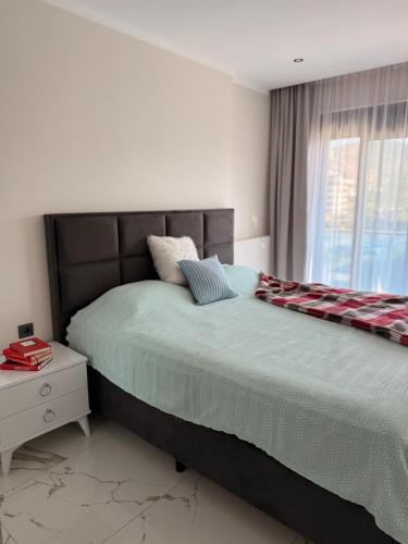a bedroom with a large bed and a window at Modern, Pool with slide,150m to beach in Alanya