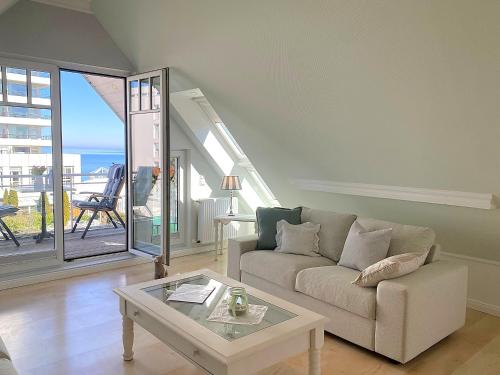 a living room with a couch and a table at Haus Anholt in Timmendorfer Strand