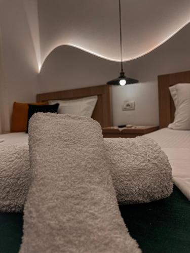a bedroom with a bed with a rug on it at Guest House Juald in Gjirokastër