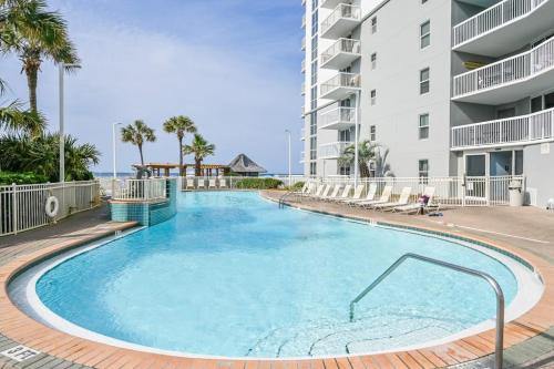a large swimming pool in front of a building at Pelican Beach Resort 1502 in Destin