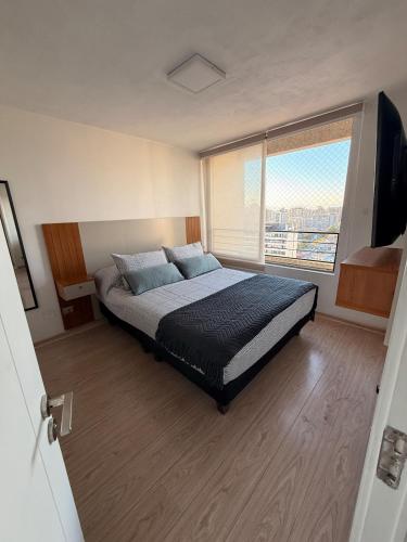 a bedroom with a bed and a large window at Ivan Suite More than accommodation an experience in Santiago