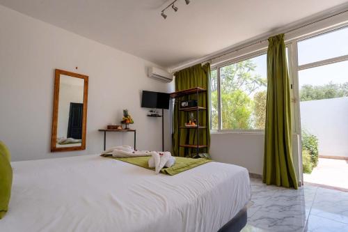 a bedroom with a large bed and a large window at DOMAINE DU DOUAR in Marrakesh