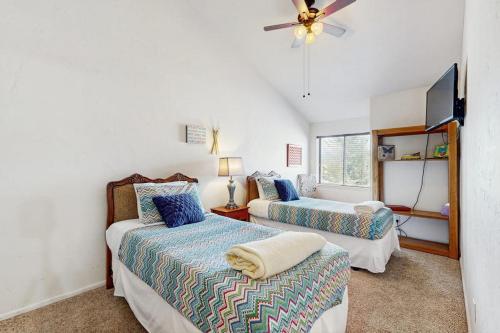 a bedroom with two beds and a ceiling fan at Pines 4031 in Pagosa Springs