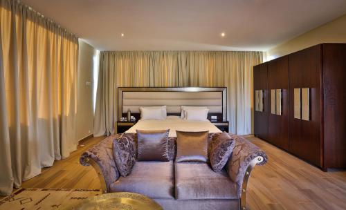 a large bedroom with a bed and a couch at Palais Amador in Oulad Mazoug
