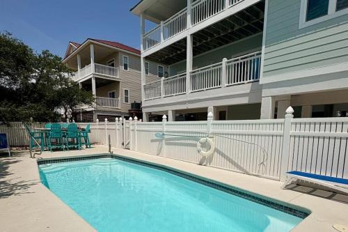 a swimming pool in front of a apartment building at Serenity Now in St. George Island