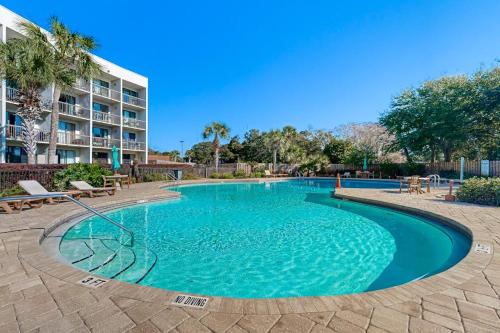 a large swimming pool in front of a building at Pirates Bay B314 in Fort Walton Beach