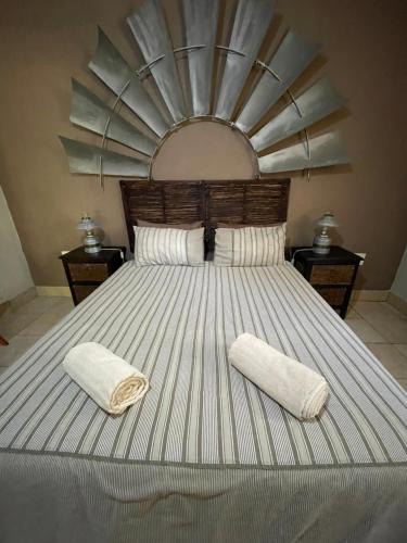 a large bed with two towels on top of it at Bush Lovers Lodge in Modimolle