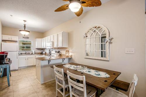 a kitchen with a wooden table and a dining room at Villas on the Gulf J6 in Pensacola Beach