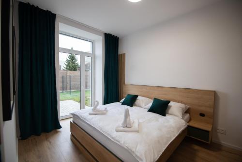 a bedroom with a large bed with a large window at One Eleven 111 in Liptovský Mikuláš