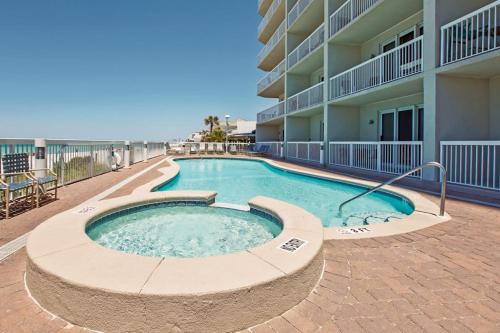 a swimming pool in front of a apartment building at Seychelles Beach Resort 2004 in Panama City Beach