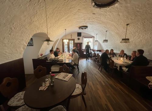 a group of people sitting at tables in a restaurant at Stadthotel Drosendorf - zum Goldenen Lamm - Failler in Drosendorf Altstadt