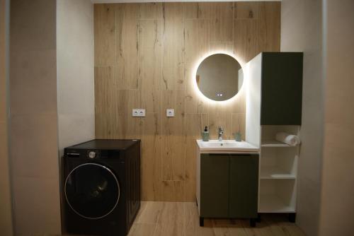 a bathroom with a washing machine and a sink at One Eleven 111 in Liptovský Mikuláš