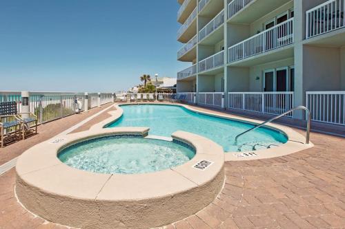 a swimming pool in front of a building at Seychelles Beach Resort 2001 in Panama City Beach