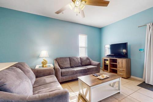 a living room with a couch and a flat screen tv at Villas on the Gulf K-2 in Pensacola Beach