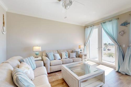 a living room with a couch and a table at Tranquil Harbour #211 in Mexico Beach