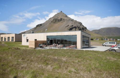 a large building with a mountain in the background at Fell Holiday Home in Stapi