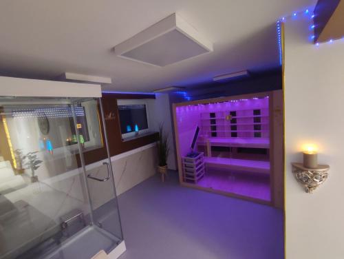a purple bathroom with a shower and a sink at VIP Wellness apartma Immortality in Zgornja Velka