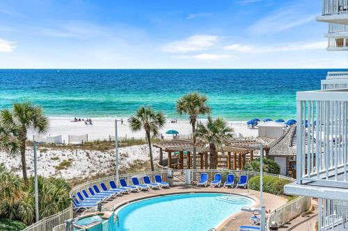 a view of the beach from the balcony of a resort at Pelican Beach Resort 415 in Destin