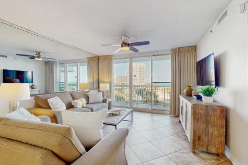 a living room with a couch and a tv at Pelican Beach Resort 415 in Destin