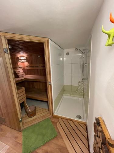 a bathroom with a walk in shower and a glass shower stall at Zbilje Lake house in Medvode