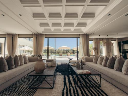 a large living room with couches and a large window at Maison Azen - Moroccan Luxury Stay in Essaouira