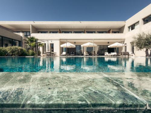 a swimming pool in front of a building at Maison Azen - Moroccan Luxury Stay in Essaouira
