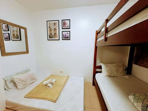 a bedroom with two bunk beds with towels on them at 727 Anabelle Residence at Marina Spatial Condominium in Dumaguete