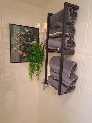 a pile of towels on a shelf in a bathroom at MarkthofApartment in Erfurt