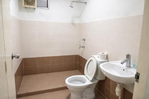 a bathroom with a toilet and a sink at JAA Homes 1-8 Pax Family Stay Jalan UMS KK in Kota Kinabalu