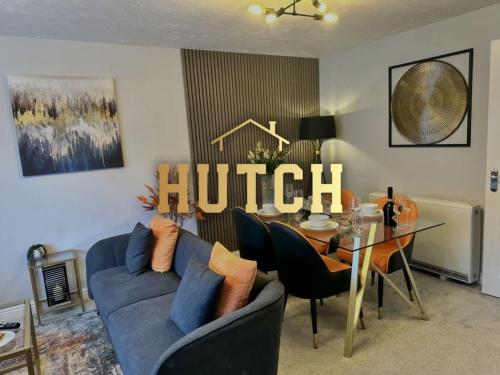 a living room with a blue couch and a table at No56 - 2-bed Boutique Apartment - Hosted by Hutch Lifestyle in Leamington Spa
