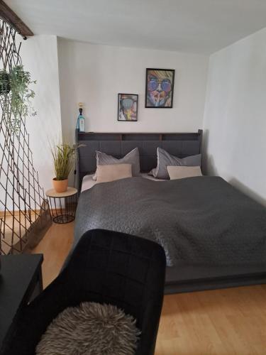 a bedroom with a bed and a couch in it at MarkthofApartment in Erfurt
