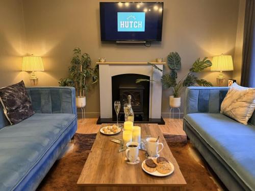 a living room with two blue couches and a coffee table at No50 - 2-bed Boutique Apartment - Hosted by Hutch Lifestyle in Leamington Spa