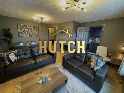 a living room with two leather couches and a couch at No24 - 2-bed Boutique Apartment - Hosted by Hutch Lifestyle in Leamington Spa