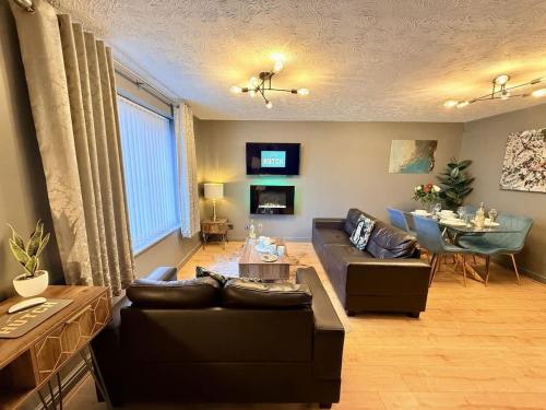 a living room with a couch and a table at No24 - 2-bed Boutique Apartment - Hosted by Hutch Lifestyle in Leamington Spa