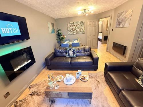 a living room with a couch and a table at No24 - 2-bed Boutique Apartment - Hosted by Hutch Lifestyle in Leamington Spa
