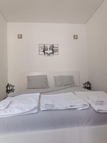 a white bed with two white towels on it at Porto Histórico - pet friendly in Porto
