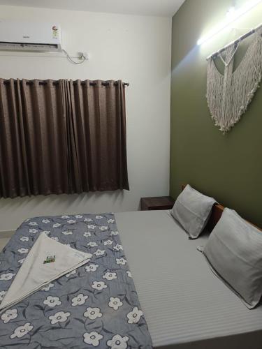 a bedroom with a bed with a blanket with sheep on it at Bn Homestay in Mysore