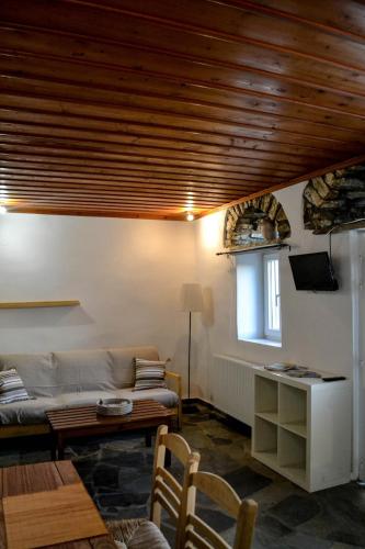 a living room with a couch and a table at Anéza house tinos in Skaládhos