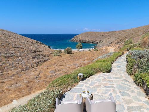 a stone path leading to the ocean on a hill at Agelos Beachfront Villa in Korissia