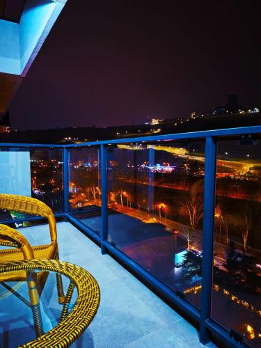 a balcony with a view of a city at night at Spacious Riverside Apartment in Central Tbilisi with Balcony in Tbilisi City
