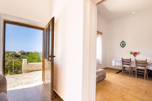 a room with a door leading to a room with a view at Minas House in Mesochórion