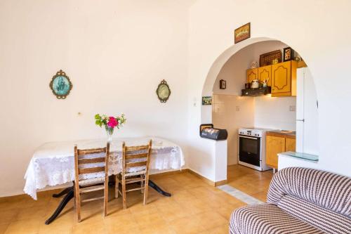 a kitchen with a table and chairs in a room at Minas House in Mesochórion