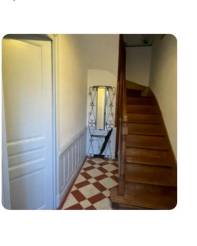 a hallway with a staircase and a stair case at Maison des chateaux in Bléré