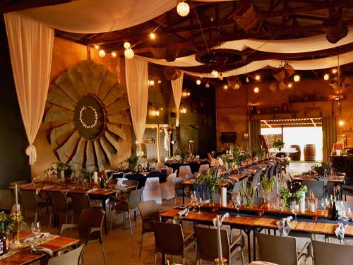 a large banquet hall with tables and chairs at Excelsior Country House in Porterville